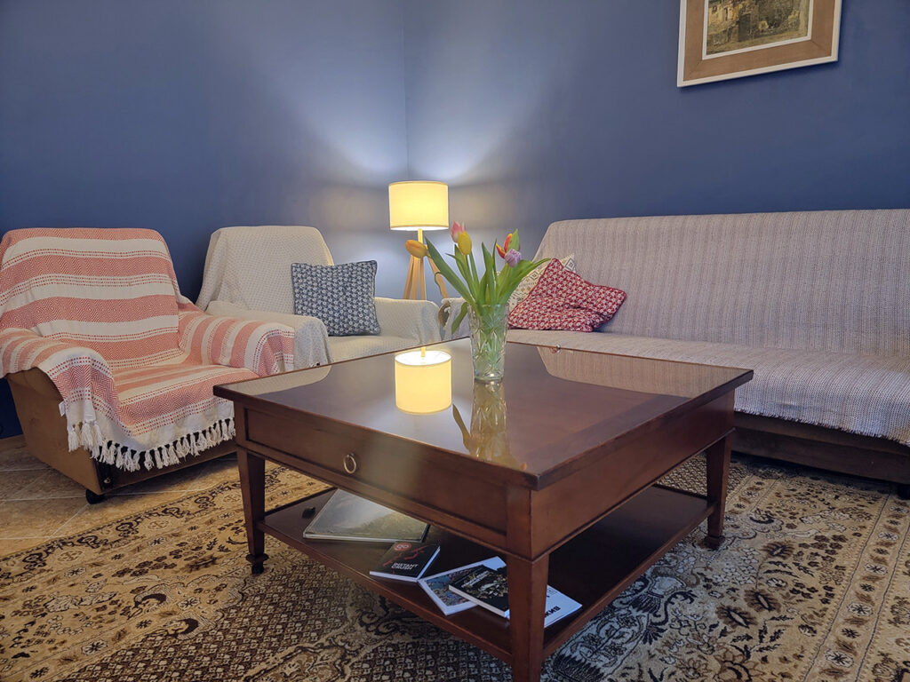 A living room with large coffee table painted with blue nova 825